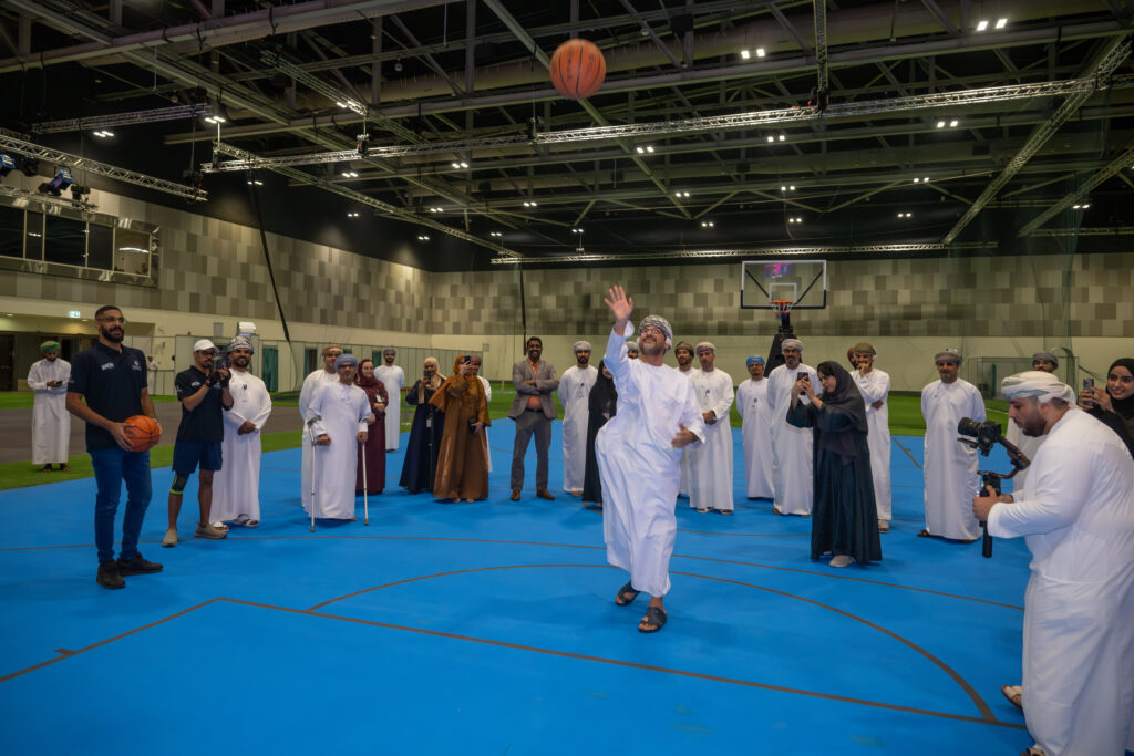 Ahmed al Humaidi, Chairman of Muscat Municipality, throws a ball to basket as the summer sports event opens at OCEC, Muscat